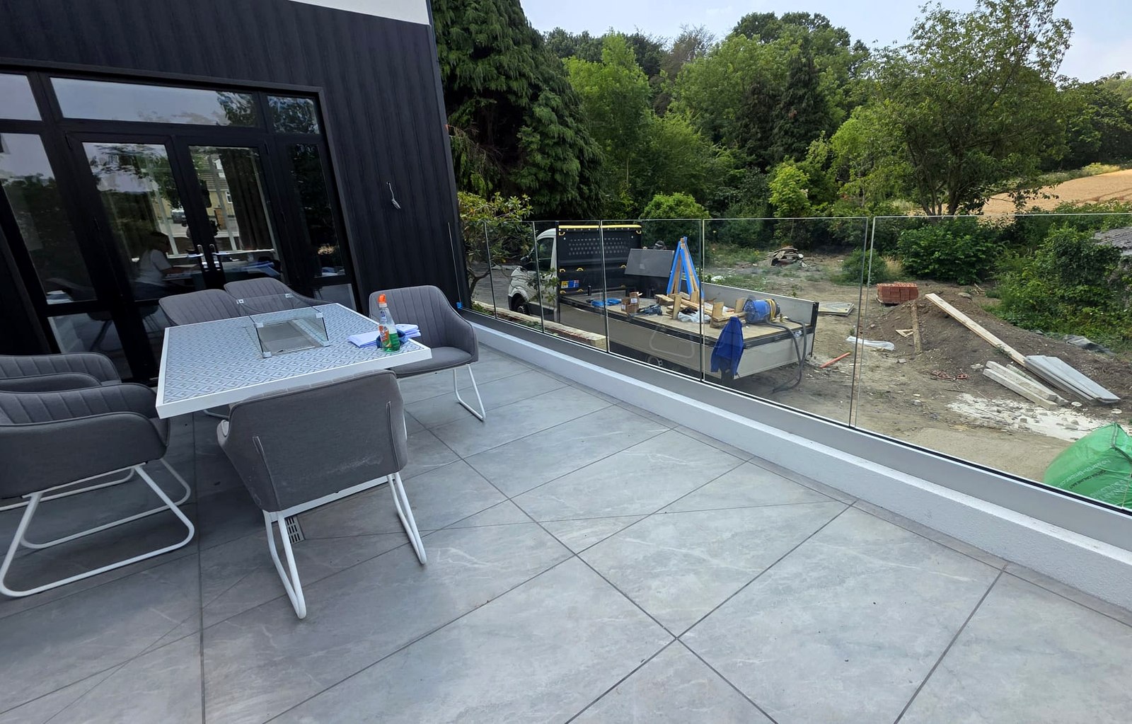 Frameless glass patio balustrade keeping a clear countryside view from a raised terrace, Barnsley